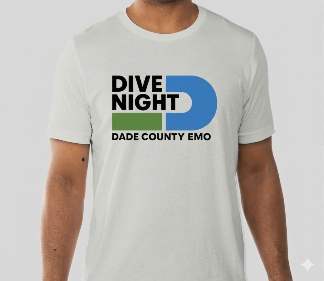 Person wearing a silver t-shirt with 'Dive Night Dade County Emo' design on a light gray background